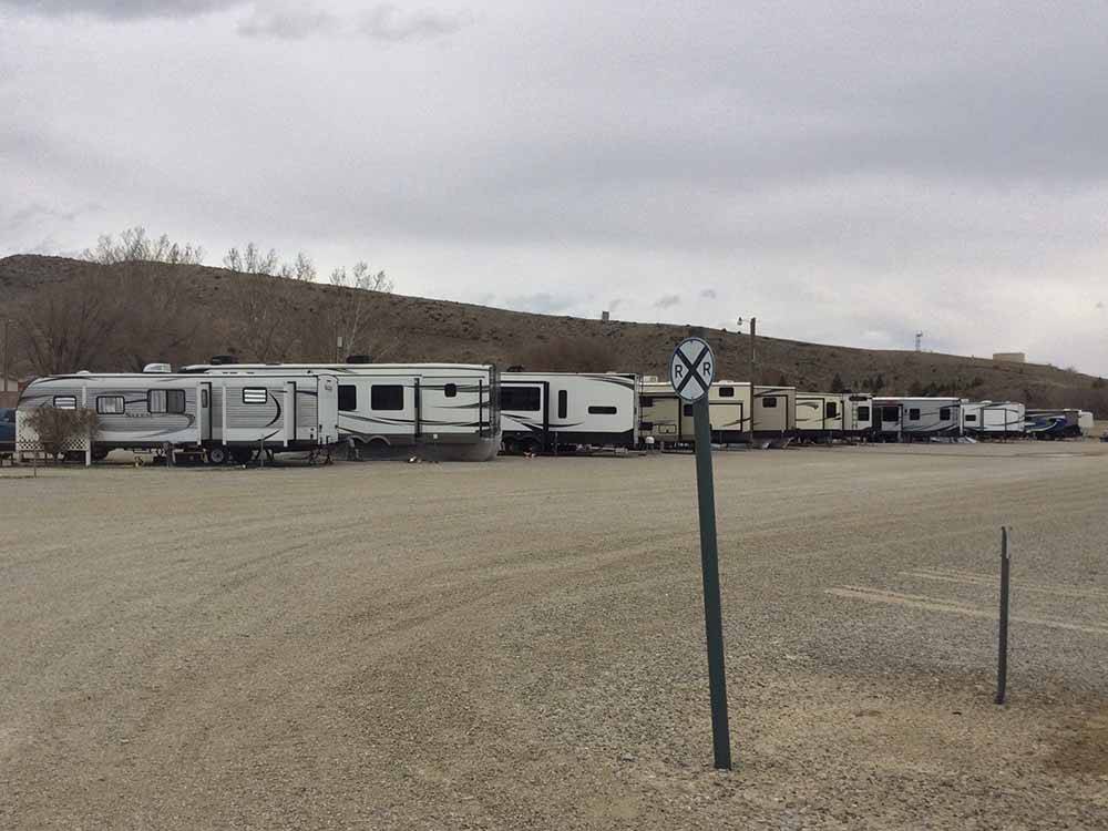 A row of trailers in gravel at WESTERN HILLS CAMPGROUND