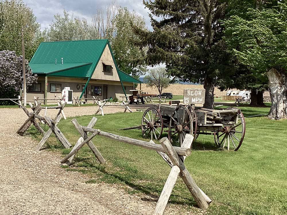 An old wooden wagon in the grass at RUBY VALLEY CAMPGROUND & RV PARK