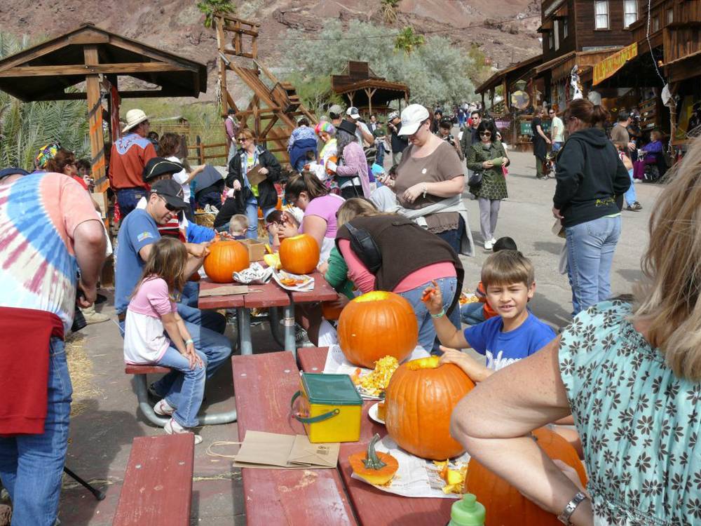 Families carving pumpkins in town