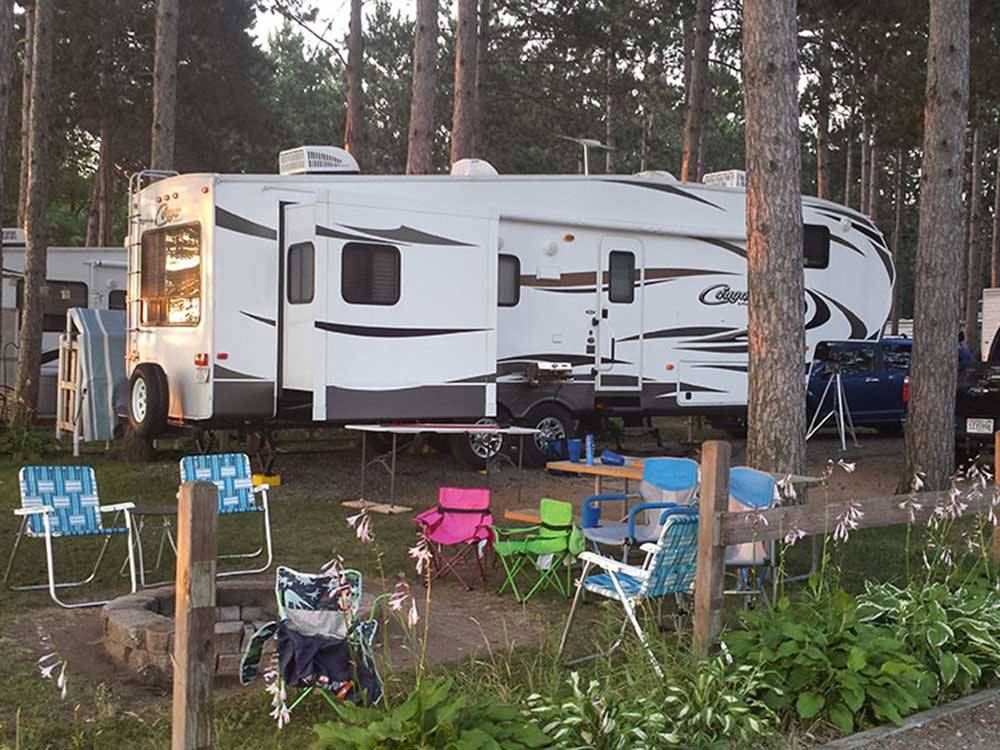 Trailers camping at campsite at LAKE DUBAY SHORES CAMPGROUND