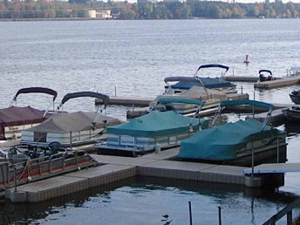 A group of boats on the dock at LAKE DUBAY SHORES CAMPGROUND