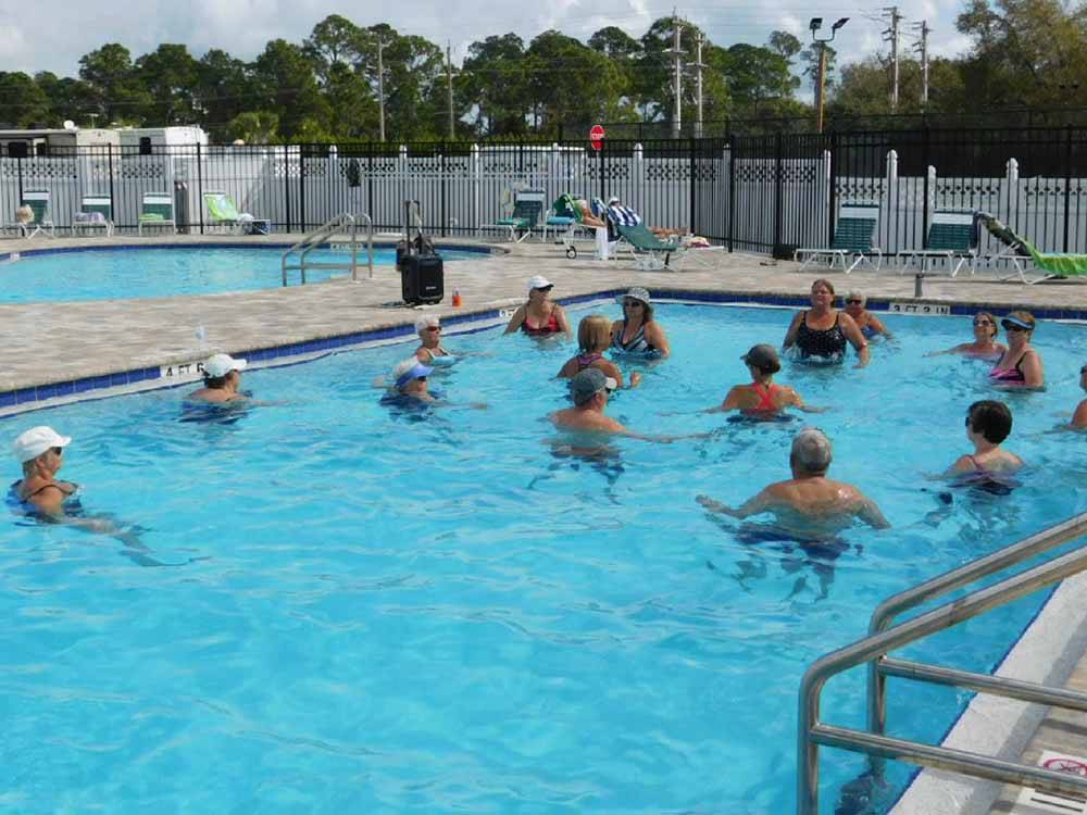 People exercising in one of the pools at UPRIVER RV RESORT