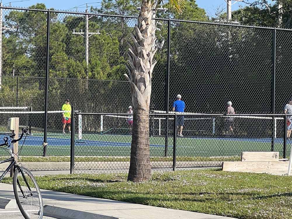 Couples playing pickleball at UPRIVER RV RESORT
