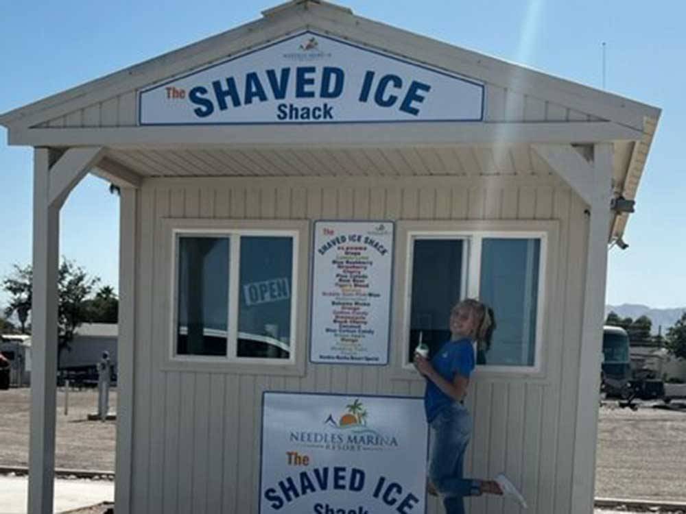 A girl in front of the Shaved Ice Shack at NEEDLES MARINA RESORT