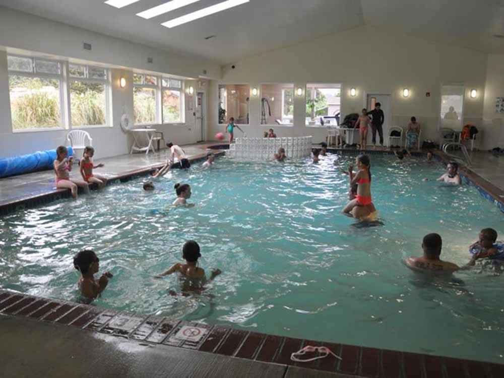 Families enjoying the indoor swimming pool at CAPE KIWANDA RV RESORT & MARKETPLACE