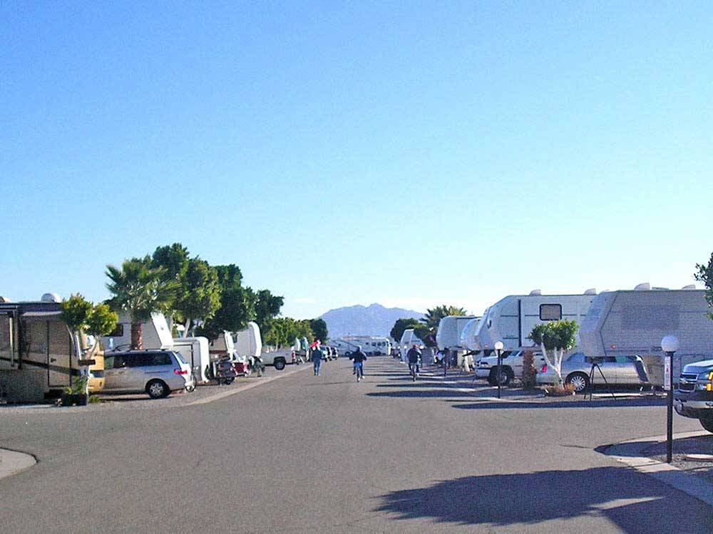 People biking near travel trailers at ENCORE DESERT PARADISE