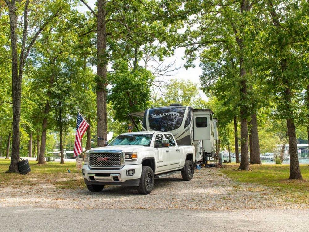 Trailer parked next to pick up truck at Port Of Kimberling Resort & Campground