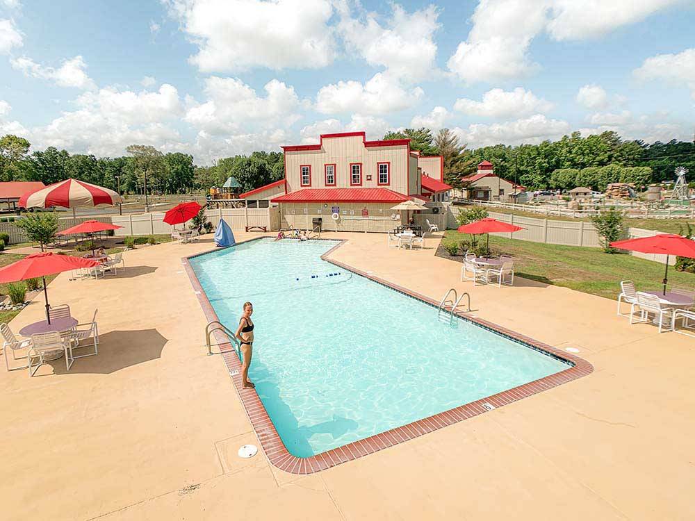 Young girl standing next to the swimming pool at SUN OUTDOORS OCEAN CITY GATEWAY