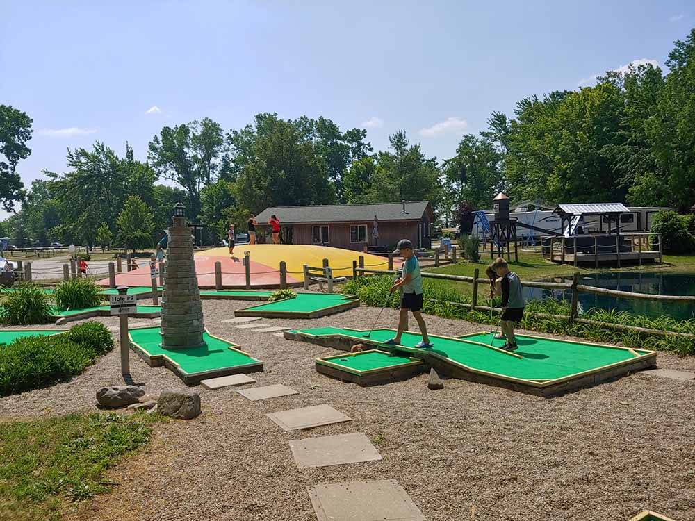Two kids playing miniature golf at INDIAN CREEK CAMP & CONFERENCE CENTER