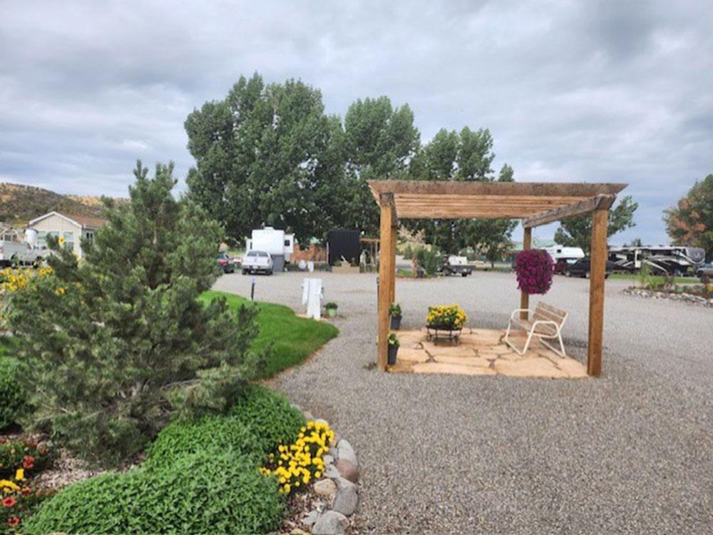 A pergola with a bench underneath at MEADOWS OF SAN JUAN RV RESORT