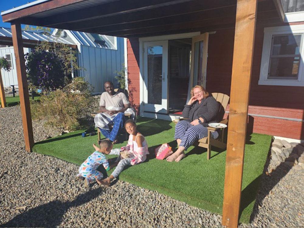 People sitting under a deck at MEADOWS OF SAN JUAN RV RESORT