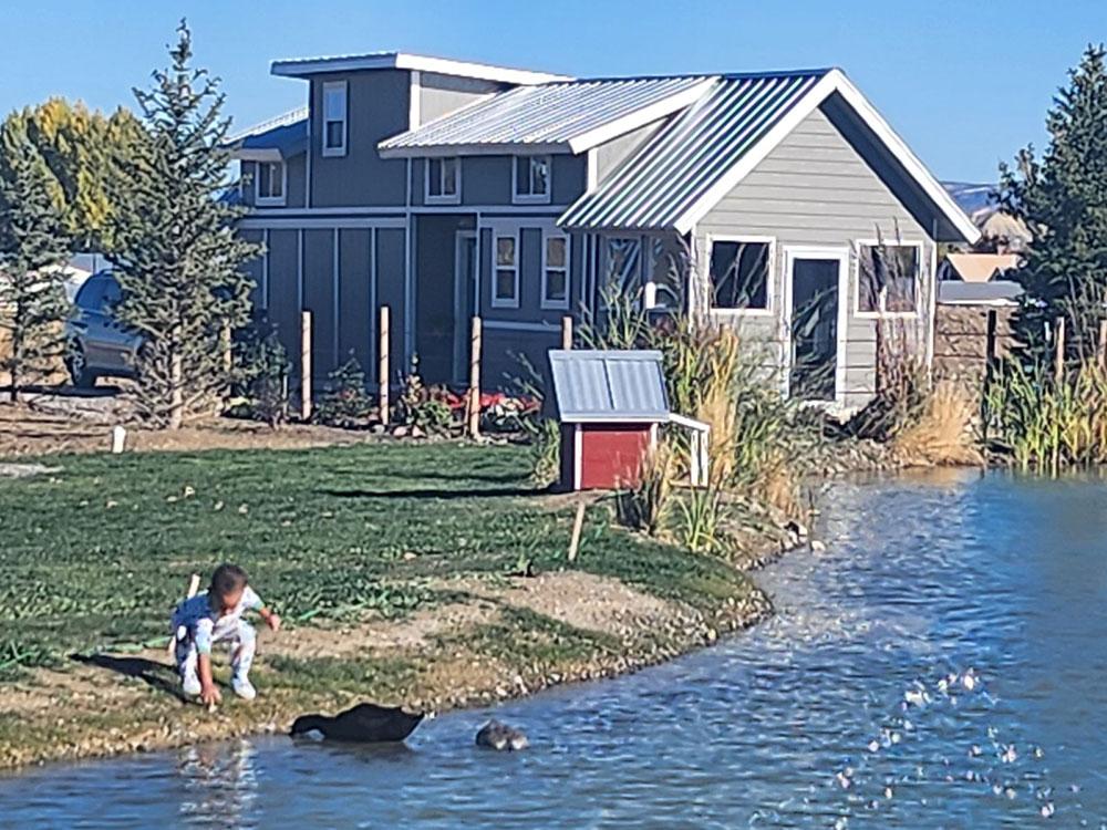 Child feeding a duck at MEADOWS OF SAN JUAN RV RESORT