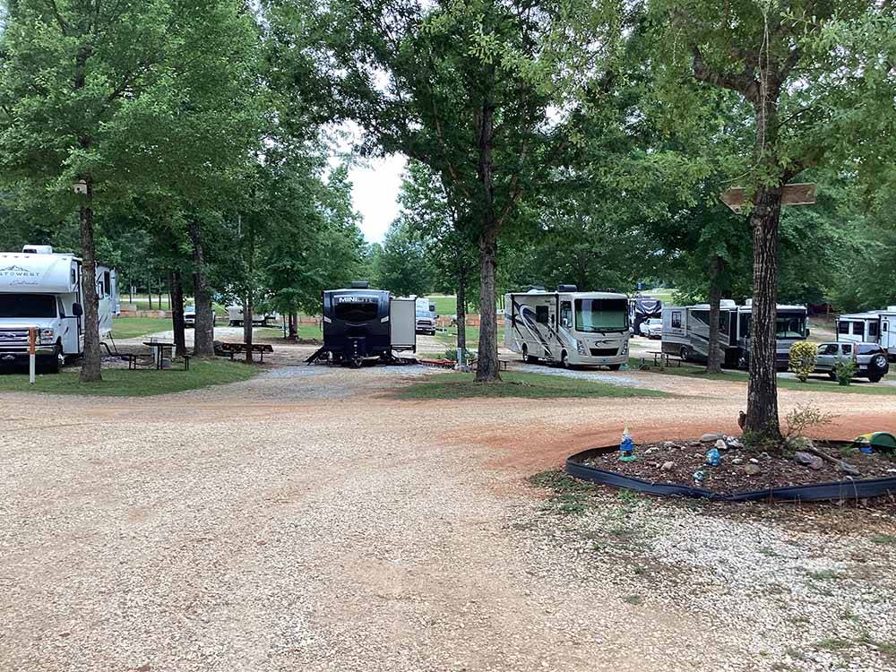 A row of motorhomes and trailers parked in gravel sites at LAKESIDE RV PARK