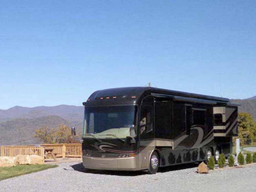 Class A motorhome in a gravel site at MAMA GERTIE'S HIDEAWAY CAMPGROUND