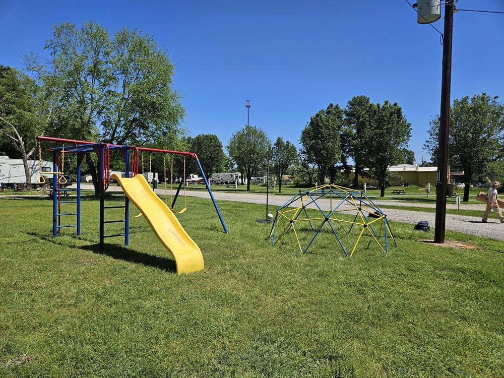 The playground in a grassy area at BOBCAT CROSSING RV COMMUNITY