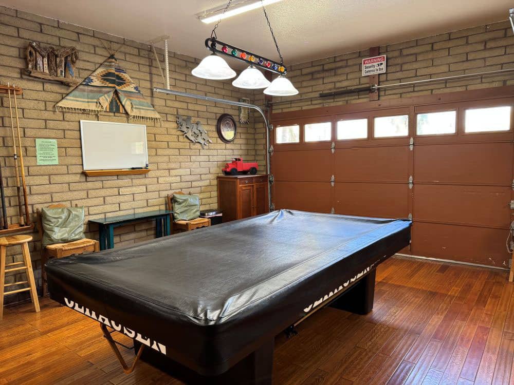 A covered billiard table in the rec hall