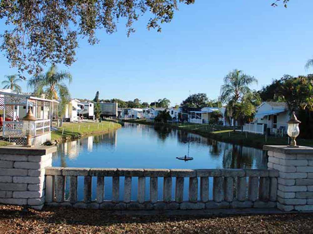 A lake between the manufactured homes at RAINTREE RV RESORT