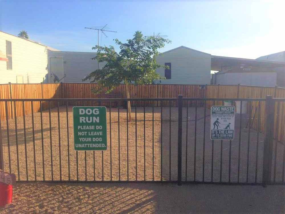 The fenced in dog run area at DESERT SHADOWS RV RESORT