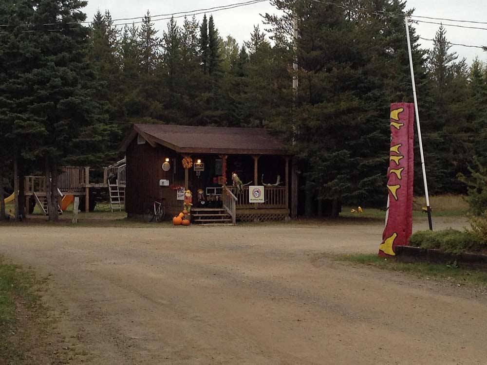 Small wooden structure with porch and Good Sam sign at WAWA RV RESORT & CAMPGROUND