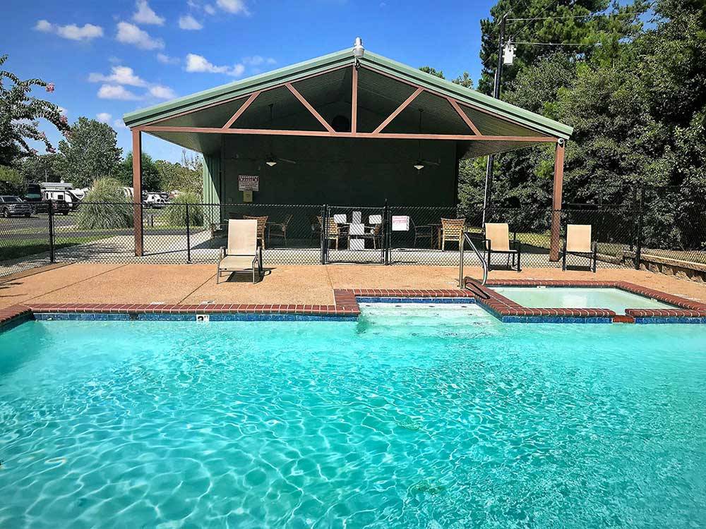 Swimming pool and chaise lounges at FERNBROOK PARK