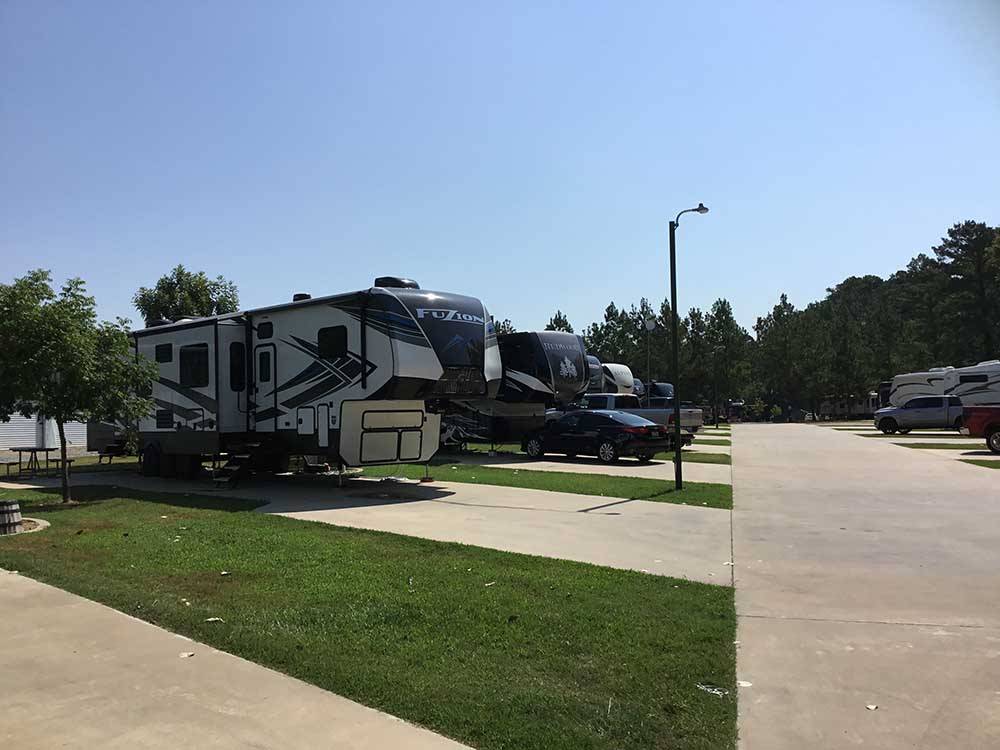 Fifth wheel and other RVs parked on-site at FERNBROOK PARK