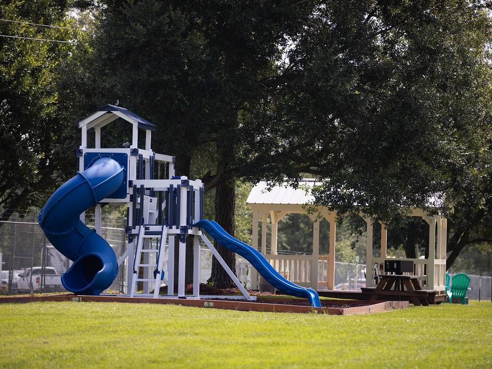 Playground equipment next to a covered sitting area at Bayberry RV Park