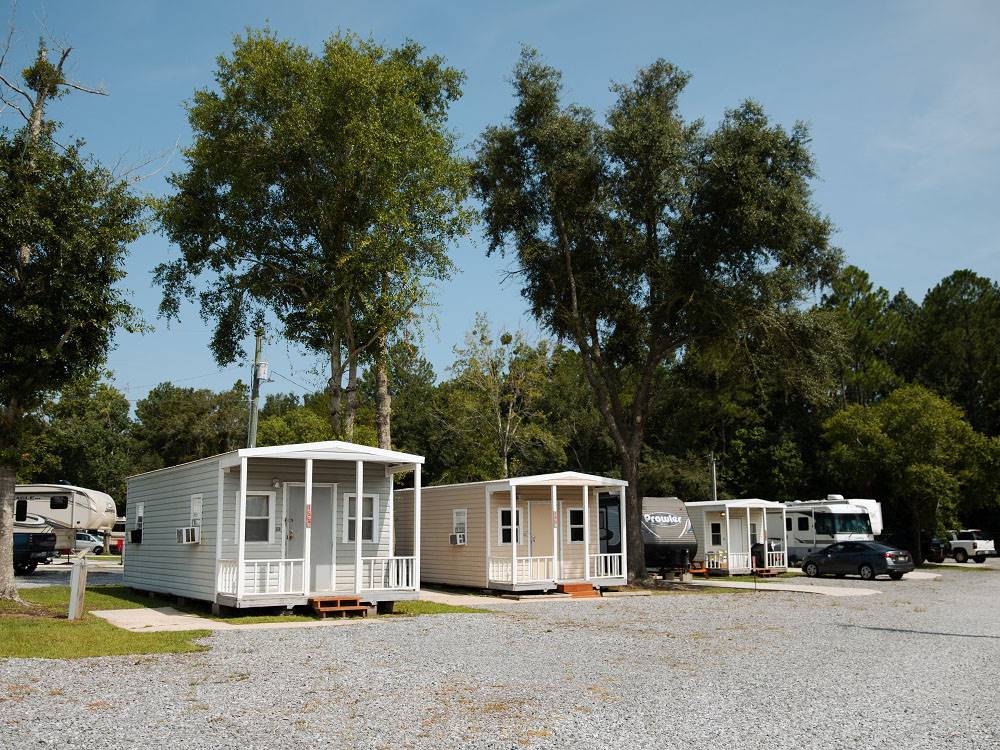 A row of rentals along a gravel road at Bayberry RV Park