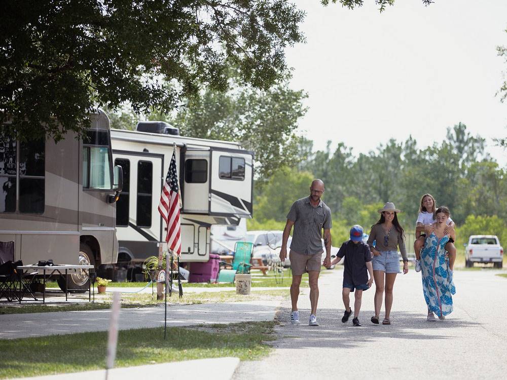 A family walking down a paved road at Bayberry RV Park