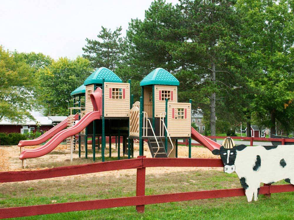 Playground with cut out of a cow on fence at THOUSAND TRAILS GETTYSBURG FARM