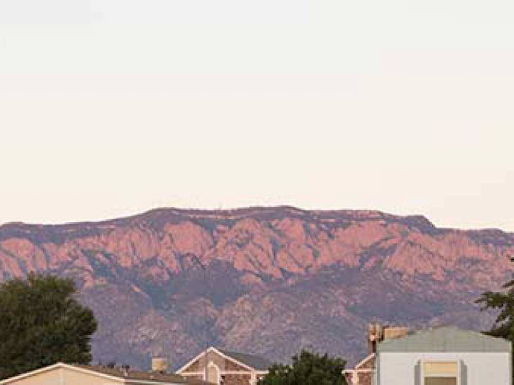Rooftops with red desert mountains in background at CORONADO VILLAGE RV RESORT