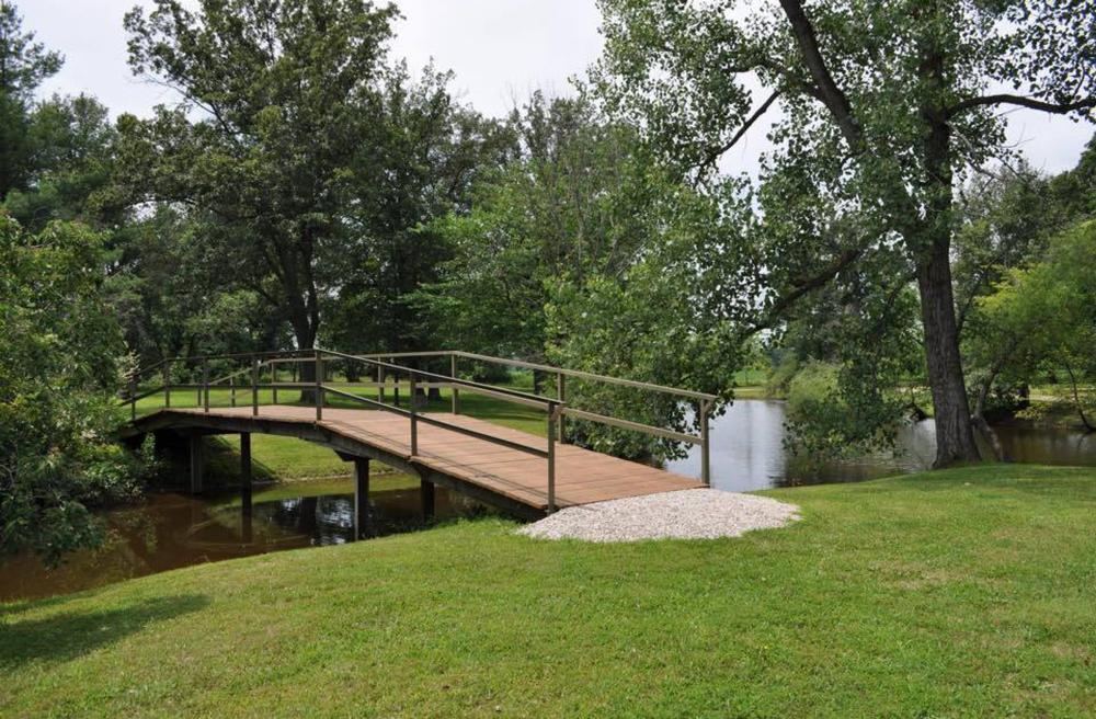 Lake with bridge at site Hickory Holler Campground