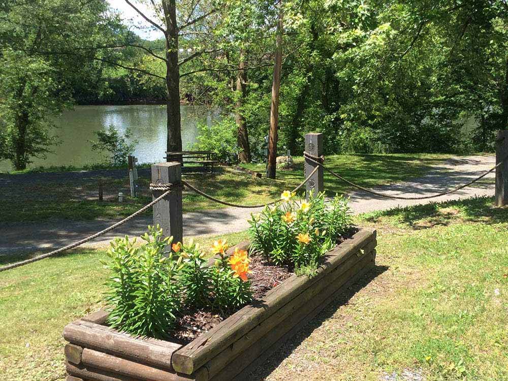 A flower planter box along the water at WATERSIDE CAMPGROUND & RV PARK