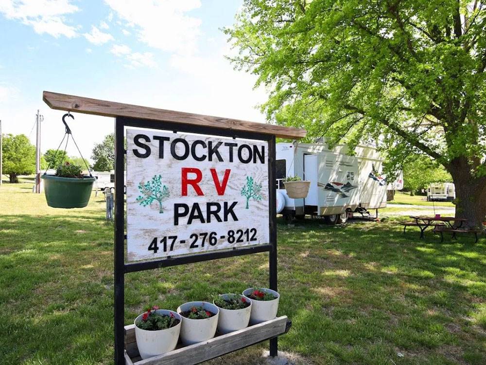 Sign of the park name with flower pots underneath