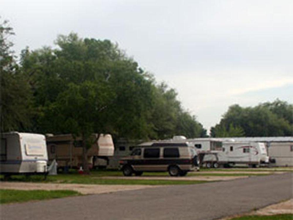 RVs at tree-lined sites at SWEET GUM MOBILE HOME AND RV COMMUNITY