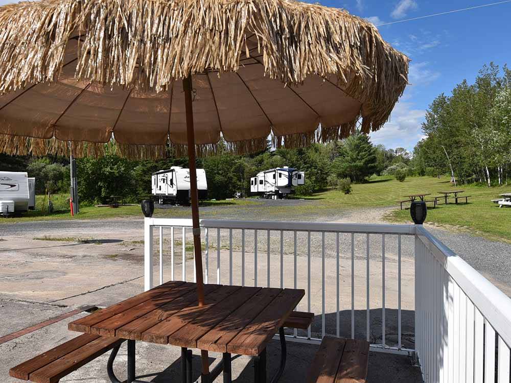 A patio table with an umbrella at THE WILLOWS RV PARK & CAMPGROUND