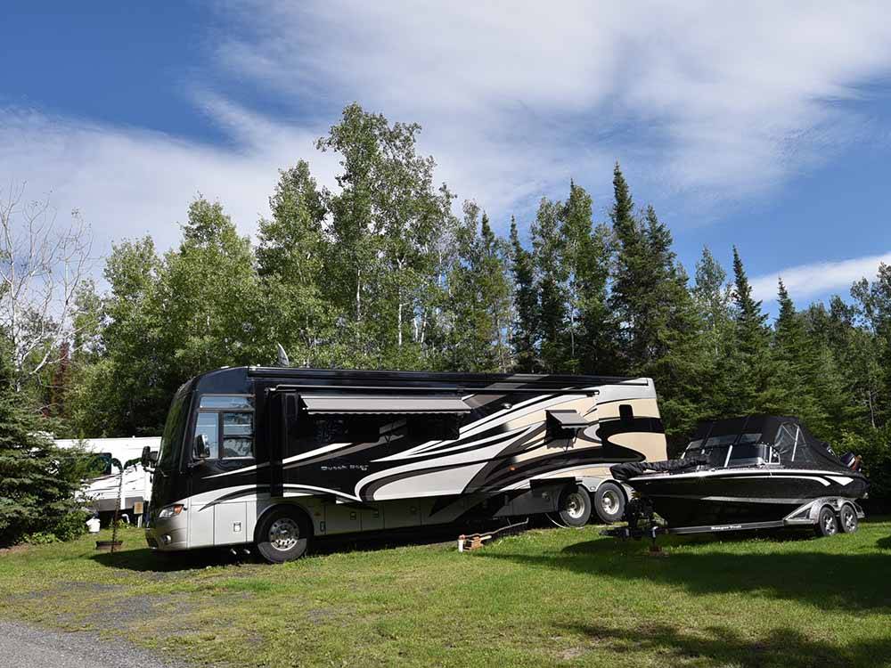 A motorhome in a grassy RV site at THE WILLOWS RV PARK & CAMPGROUND