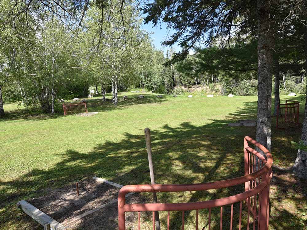 The horseshoe pits in grass at THE WILLOWS RV PARK & CAMPGROUND