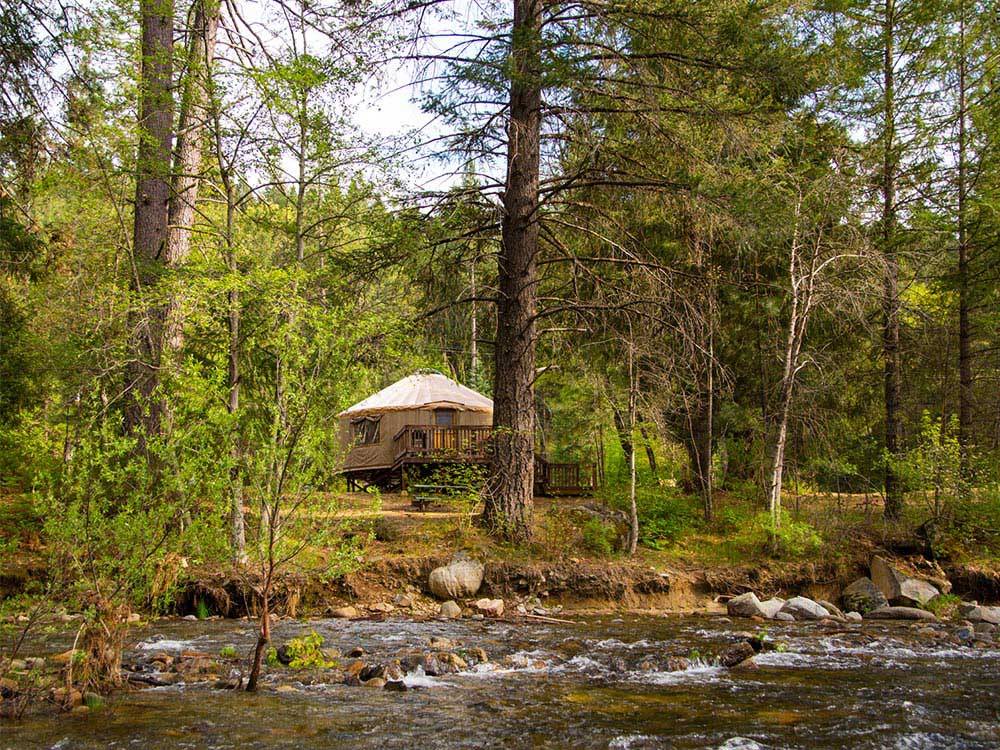 Yurt camping next to the river at THOUSAND TRAILS YOSEMITE LAKES