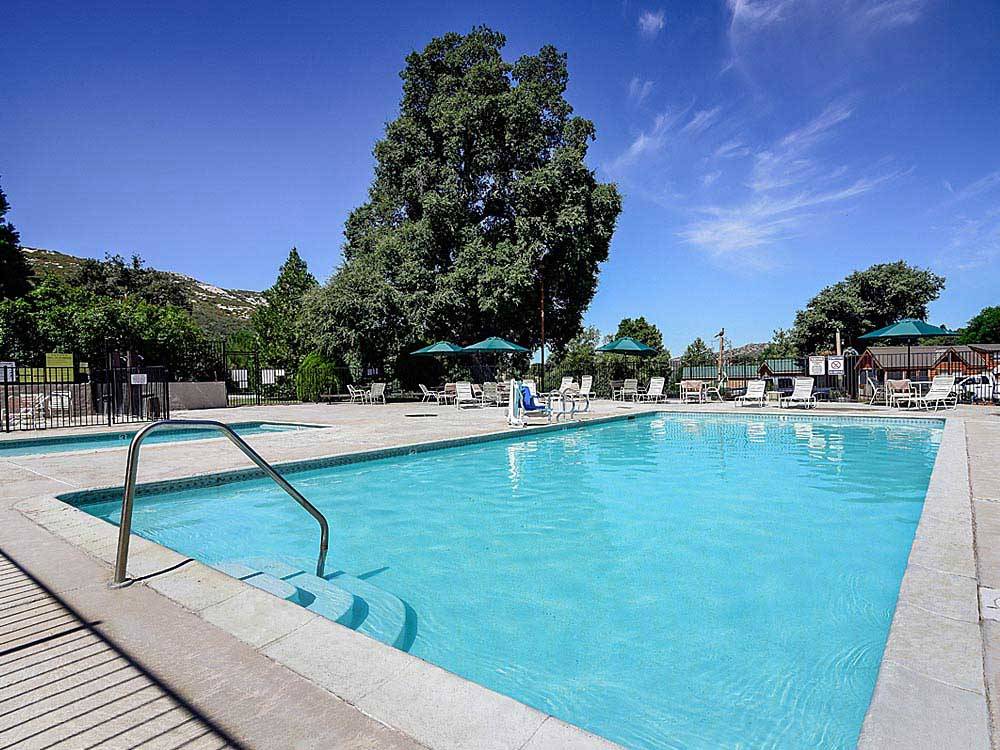 Swimming pool with outdoor seating at THOUSAND TRAILS OAKZANITA SPRINGS