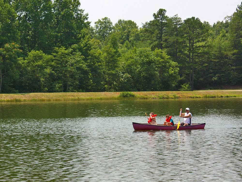 Man boating on lake with kids at THOUSAND TRAILS LYNCHBURG