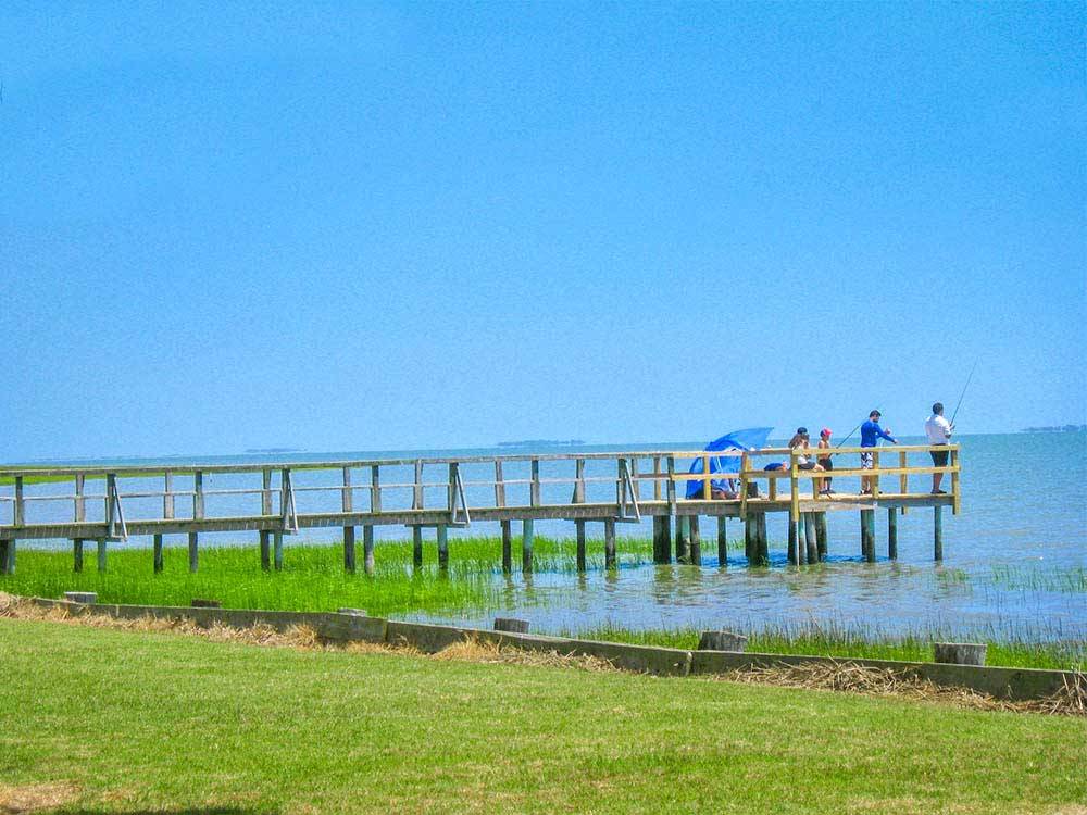 Pier on lake with people fishing at THOUSAND TRAILS VIRGINIA LANDING