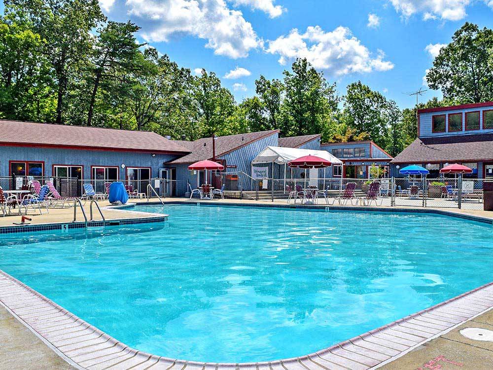 Swimming pool with outdoor seating at THOUSAND TRAILS WILLIAMSBURG