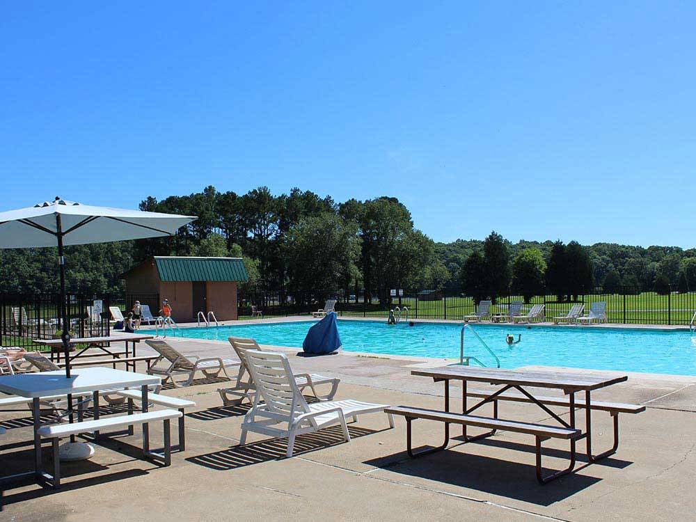 Swimming pool with outdoor seating at THOUSAND TRAILS NATCHEZ TRACE