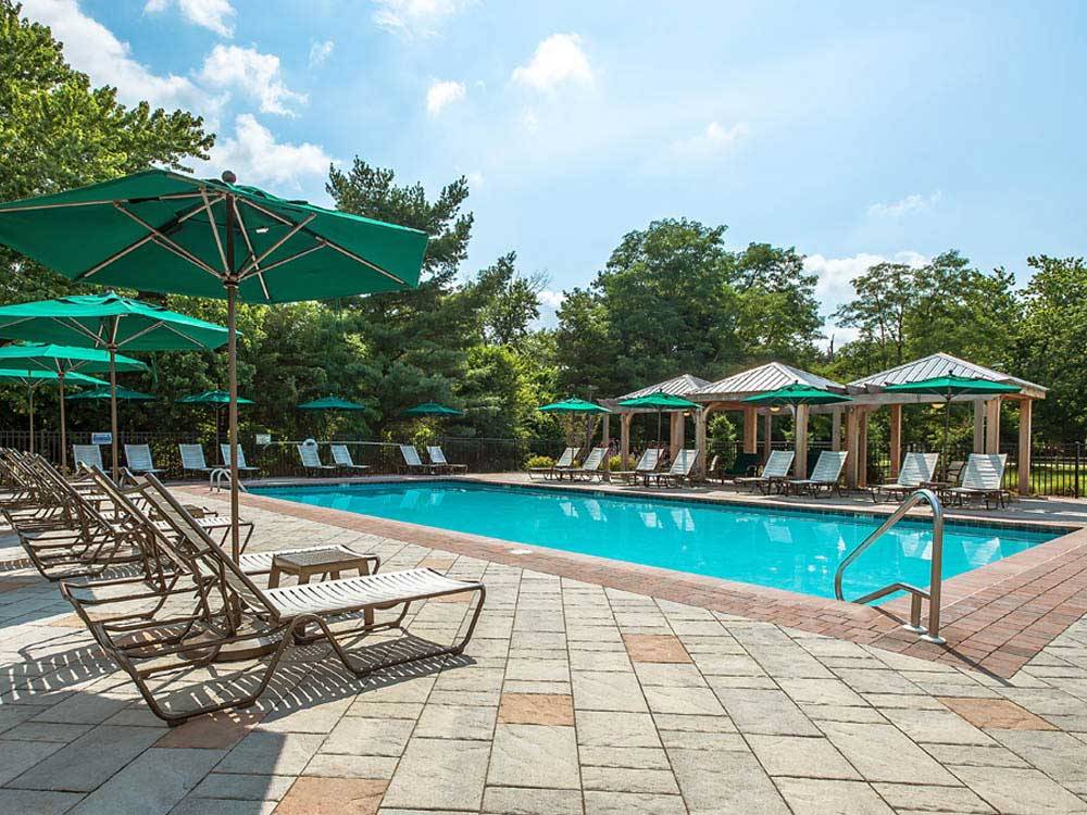 Swimming pool with outdoor seating at THOUSAND TRAILS CHESTNUT LAKE