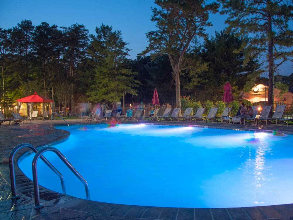 Swimming pool with outdoor seating at THOUSAND TRAILS SEA PINES