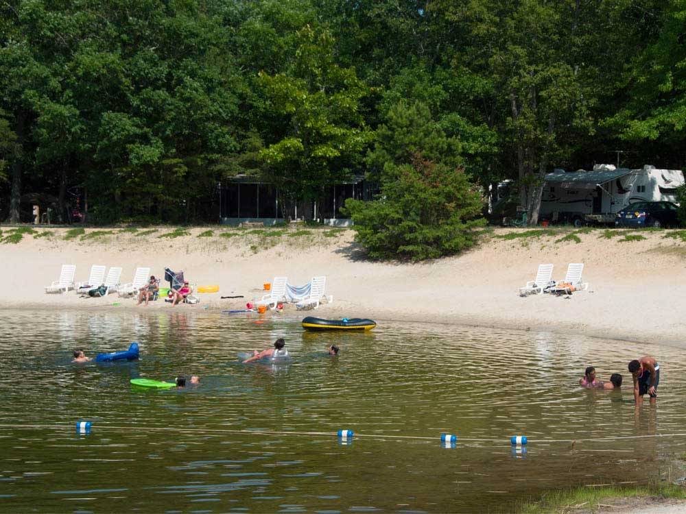 Campers swimming in the lake at THOUSAND TRAILS SEA PINES
