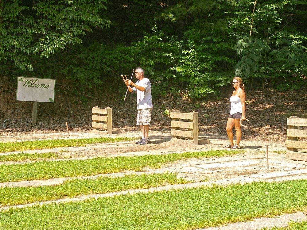 Couple playing horseshoes at THOUSAND TRAILS GREEN MOUNTAIN