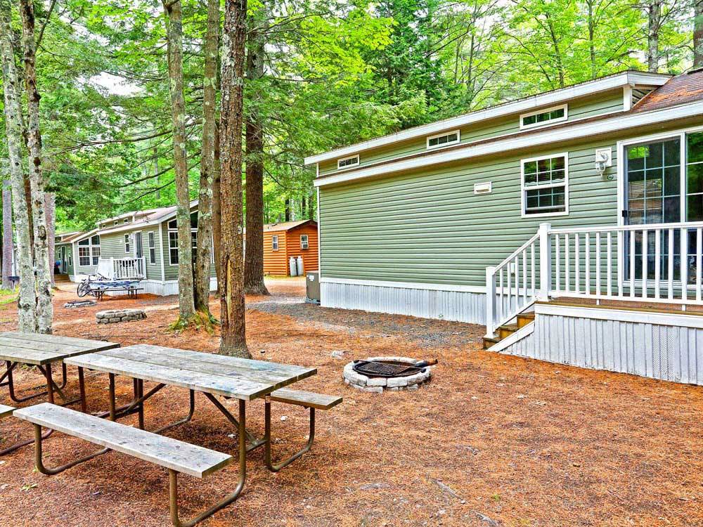 Cabins with decks and picnic tables at THOUSAND TRAILS MOODY BEACH