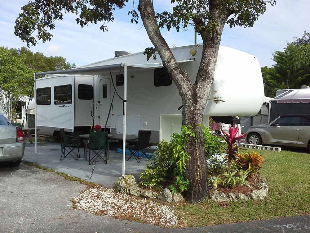 Trailer with table and chairs at BOARDWALK RV RESORT