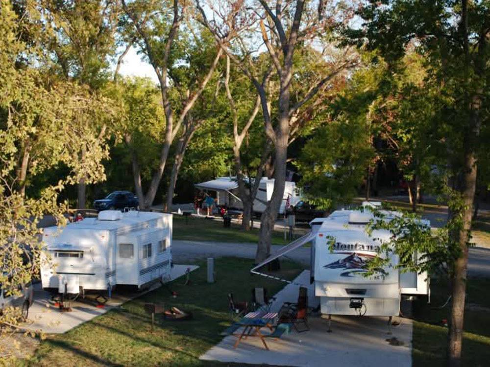 Travel trailers parked at shaded sites